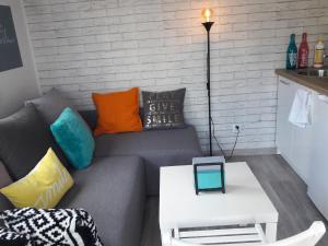 a living room with a couch and a table at Dobranocka - pokoje i całoroczne domki blisko Energylandii in Zator