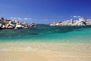 a beach with rocks in the water at Résidence hôtelière A TRAMA in Bonifacio