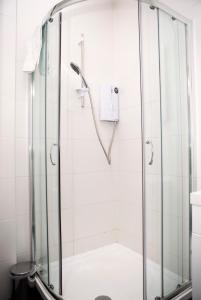 a shower with a glass door in a bathroom at 1A, Opera House 1st Floor by Indigo Flats in London