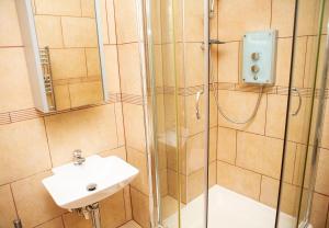 a bathroom with a shower and a sink at Apt 1, Opera House 2nd Floor by Indigo Flats in London