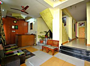 a lobby with a staircase and a waiting room at Satkar Hotel in Jaipur