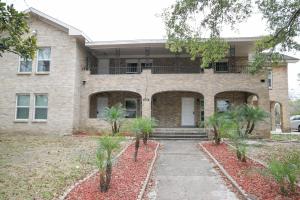 a brick house with trees in front of it at East Downtown Bungalow in Houston