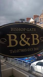 a sign for a bus stop cafe on a building at bishop gate bnb in Derry Londonderry