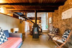 a living room with a wood stove in a room at El Zarzo de Nemesio, patio barbacoa 2 Hab 4 Pers mas 2 Max in Valdelarco