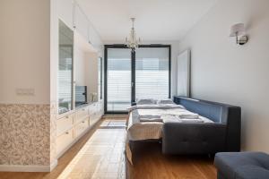 a bedroom with a bed and a large window at Airport Lirowa - P&O Serviced Apartments in Warsaw