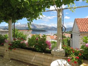 a view from the balcony of a house with flowers at Apartments Lumbarda in Lumbarda