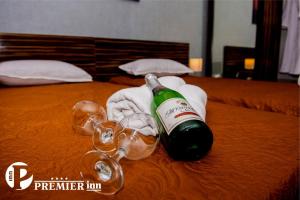a bottle of wine and glasses on a bed at Premier Inn Astana in Astana