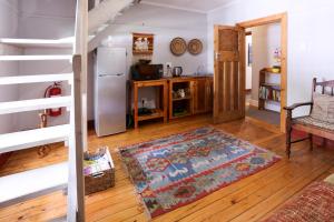 a living room with a refrigerator and a kitchen at 33 Berg Selfcatering in Swellendam