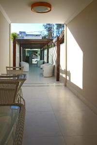 een patio met tafels en stoelen in een gebouw bij MDJ Pousada in Cabo Frio