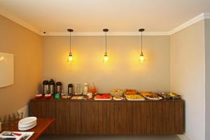 a buffet with many plates of food on it at MDJ Pousada in Cabo Frio