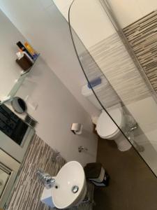 a bathroom with a white sink and a mirror at Ascot By The Sea in St Paul's Bay +13 photos