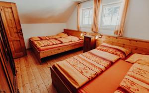 a bedroom with two beds and a window at Stegerhütte in Hinterstoder +78 photos
