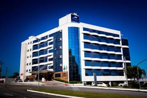 a tall white building with a sign on top of it at Iate Hotel Centro Florianópolis by RB Hotelaria in Florianópolis