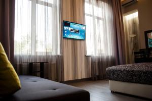 a hotel room with a bed and a television on a window at Boutique Apart - Hotel iArcadia in Odesa