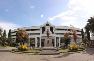 a large white building with a statue in front of it at The Shire Private Resort in Bago