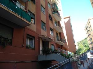 an apartment building with balconies on a street at Casa Christine in Genova