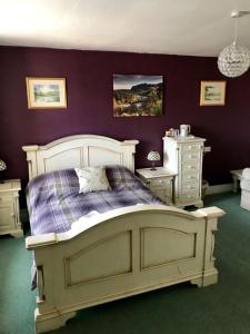 a bedroom with a large bed and two night stands at Morven in Dufftown