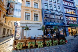 a building with a restaurant on a city street at Old Town Kalēju Street in Rīga