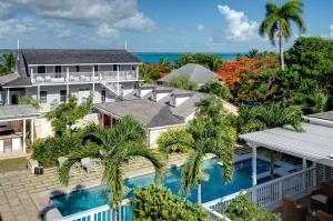 an aerial view of a house with a swimming pool and the ocean at Eleven Bahama House in Harbour Island