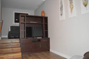 a entertainment center with a television in a living room at Driftwood Inn in Sechelt