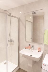 a white bathroom with a sink and a shower at Mateja&Fontana Apartment in Budva +58 photos