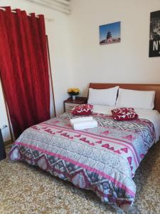 a bedroom with a bed with a red curtain at Venice Park House in Marghera