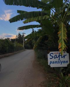 a sign on the side of a road at Safir Pansiyon in Cıralı