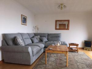 a living room with a gray couch and a coffee table at 3 Marina Quay in Lossiemouth