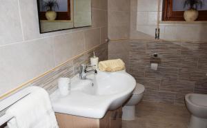 a bathroom with a sink and a toilet at Appartamenti Da Vincenza in Santa Maria Navarrese