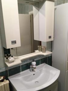 a bathroom with a white sink and a mirror at Apartman Nena in Banja Luka
