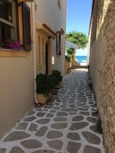 a stone walkway with plants on the side of a building at Asterias Studios & Apartments in Kalyves