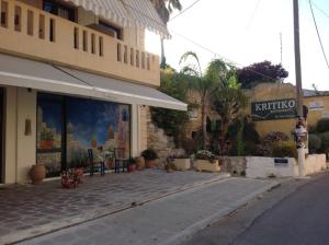 a store on a street next to a building at Asterias Studios & Apartments in Kalyves