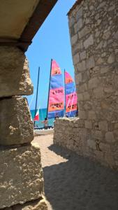 a group of sailboats in the ocean behind a stone wall at Asterias Studios & Apartments in Kalyves