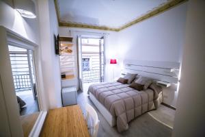 a bedroom with a bed and a large window at B&B Opera dei Pupi in Palermo