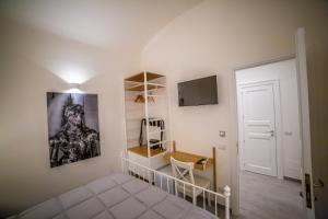 a room with a desk and a tv on a wall at B&B Opera dei Pupi in Palermo