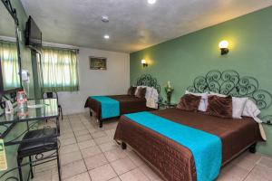 Tempat tidur dalam kamar di Hotel Mansion del Cantador
