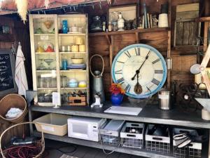 a clock sitting on top of a shelf with other items at La Boheme Living in Los Angeles