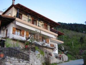 a building with balconies on the side of a mountain at Gerakofolia Rooms to Let in Konitsa