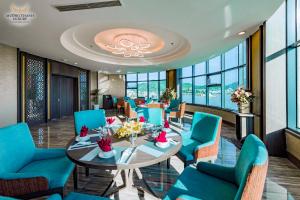 Un comedor con una mesa y sillas azules. en Muong Thanh Luxury Khanh Hoa, en Nha Trang