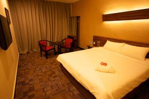 Säng eller sängar i ett rum på De Botani Hotel