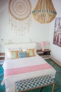a bedroom with a bed and a chandelier at Sunrise Resort in Gili Air