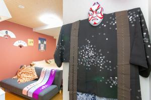 a room with a mannequin with a mask on the wall at Miyabiro 105 in Kyoto