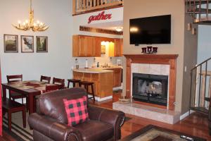 a living room with a kitchen and a fireplace at Spacious Downtown Condo Walking distance to Downtown Gatlinburg Sleeps 6 guests in Gatlinburg