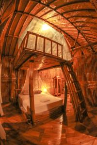 a bedroom with a bed in a wooden room at Pondok Salacca#bamboohouse# in Candidasa