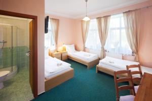 a hotel room with two beds and a bathroom at Pytloun Self Check-in Hotel Liberec in Liberec