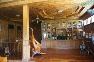 a living room with a wooden ceiling and a statue at Samnaree Garden House in Ban Phae Mai +45 photos