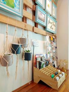 a store with potted plants hanging on the wall at Maple Inn in Kuala Lumpur