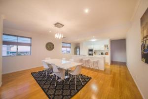 a dining room and kitchen with a table and chairs at Edge Apartment Hotel in Rockhampton