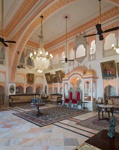 a large room with a chandelier in a building at Alsisar Mahal- Heritage Hotel in Alsīsar