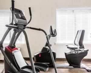 a gym with two exercise bikes and a treadmill at Days Inn by Wyndham McDonough in McDonough